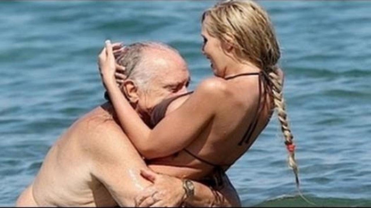 Naked women kissing with old man